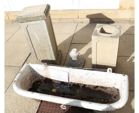 A painted cast iron wall mounted water trough; together with two composition square section garden plinths and an urn base (4