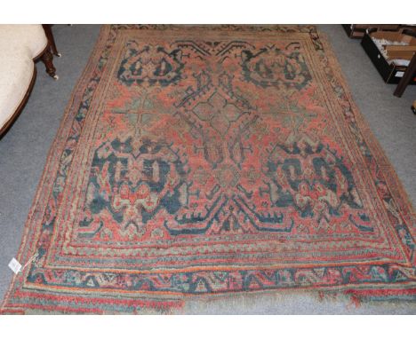 Ushak carpet, the soft brick red field with central floral head medallion enclosed by multiple narrow borders, 240cm by 191cm