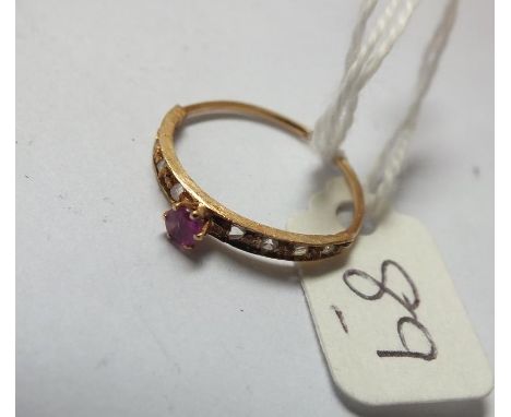 High carat gold narrow band ring set with   diamonds and a central ruby approx size N    