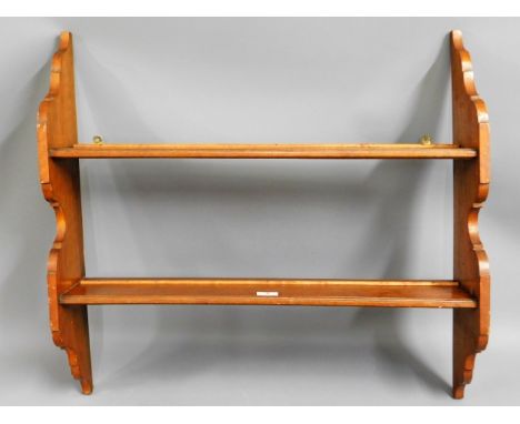 An oak wall mounted shelf unit, 31in wide