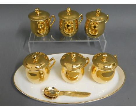 A set of six Royal Worcester gilded chocolate pots with tray