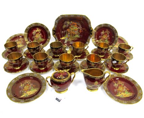 A Carlton Ware Pottery Rouge Royale Tea Service, the maroon grounds decorated in enamels with Chinoiserie landscapes, printed