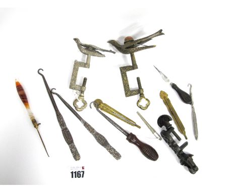 A Brass Late XIX Century Hemming Clamp, mounted with a pincushion bird and with embossed floral decoration, 12cm long; Anothe