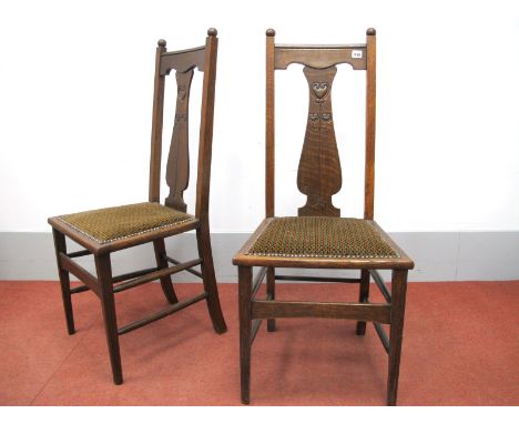 A Pair of Early XX Century Oak Art Nouveau Style Chairs, with shaped splat's, stylized flowers, upholstered seats, on taperin