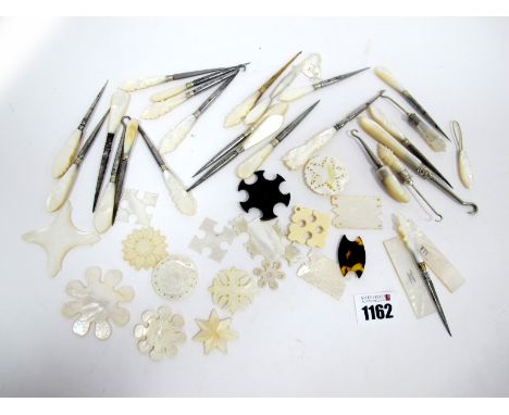 A Collection of Twenty-Five Stilettos, Needle Threaders and Button Hooks, all with mother of pearl handles. (25)