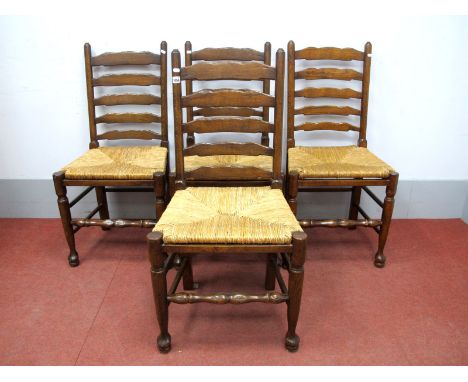 A Set of Four Titchmarsh &amp; Goodwin Style Ladder Back Dining Chairs, with rush seats, on pad feet united by stretchers. (4