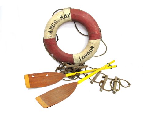 A Lapcs Bay, London Vintage Life Buoy, in red and white with black lettering, 75cm diameter; A Rope Ladder and a Pair of Padd