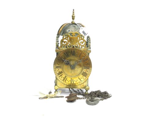 A XVII Century Brass Lantern Clock, the strapped bell over urn finials and foliate fret, each inscribed 'S.L.', the tapered c