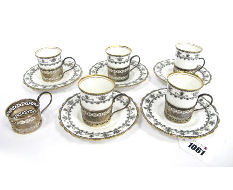 A Set of Five Aynsley Porcelain Coffee Cans and Saucers, decorated in black with scrolls and flowers within gilt rims, printe