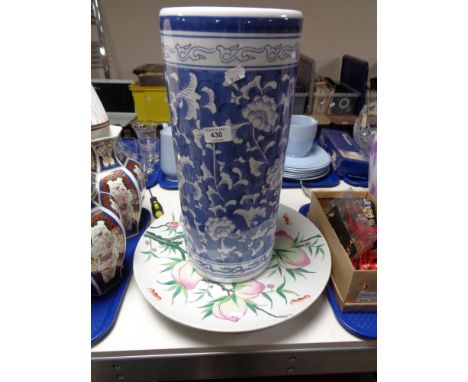 A blue and white stick pot and two ceramic chargers 