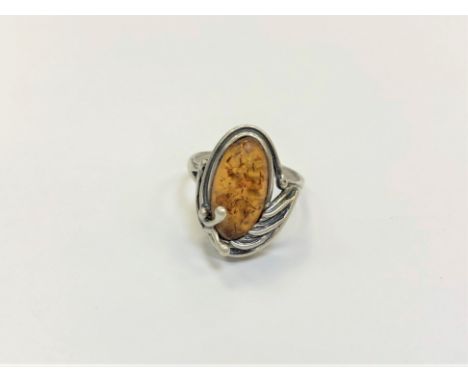 A Sterling silver ring set with amber