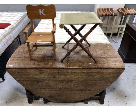 An antique oak gate leg table, child's chair and folding seat 