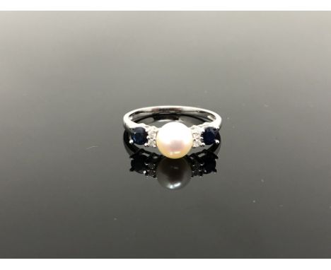 A 10ct white gold diamond sapphire and pearl ring, size O