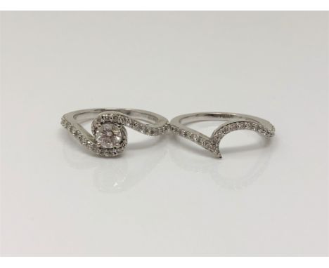 Two 18ct white gold diamond set rings - Brilliant cut four claw diamond mounted in a swirl of twenty six brilliant cut diamon