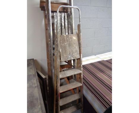 Three wooden step ladders 