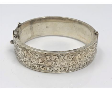 A silver bangle with engraved decoration, Birmingham 1967 CONDITION REPORT: 29.5g