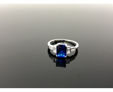 A Sterling silver Art Deco style emerald cut ring set with a blue stone, size N.