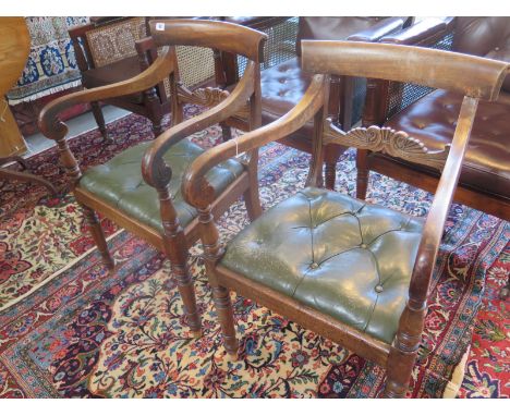 A pair of Georgian mahogany scroll arm carver chairs, with drop in button leather seats 
