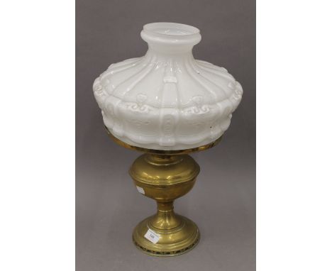A Victorian brass oil lamp with opaline glass shade. 