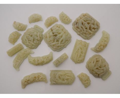 A quantity of Chinese carved and pierced jade items. The largest 8.5 cm wide.