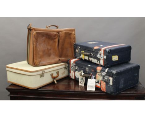A leather travelling bag and two vintage suitcases