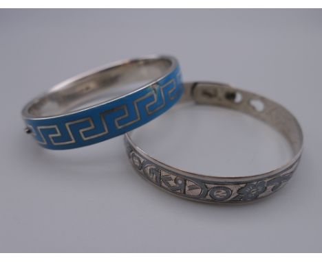 An antique silver and blue enamel Greek pattern design bracelet and a Russian silver and niello bangle. The former 6 cm wide.