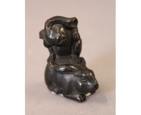 A Japanese carved wood netsuke in the form of rabbits. 4.5 cm high.