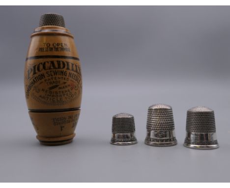 Three vintage sterling silver thimbles and an Edwardian treen 'Piccadilly' needle case.