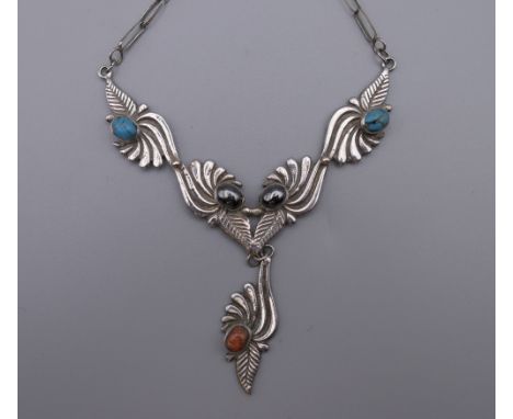 A vintage 925 silver Navajo necklace of leaf design with turquoise, coral and haematite inlay. 41 cm long.