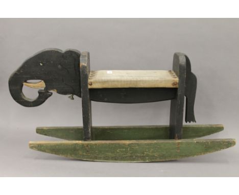 A vintage painted wooden rocking elephant. 94 cm long.