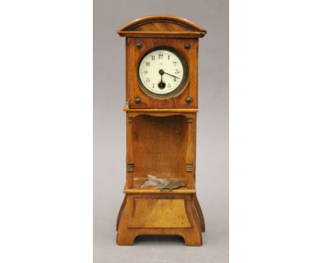 A Victorian walnut miniature longcase clock. 25.5 cm high.