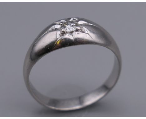 A platinum and diamond ring. Diamond approximately 0.20 carat. Ring size Q/R.