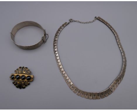 A silver necklace, a vintage silver bangle and a Victorian agate brooch. 