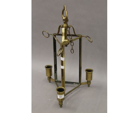 A triangular brass hanging light, lacking glass. 50 cm high.