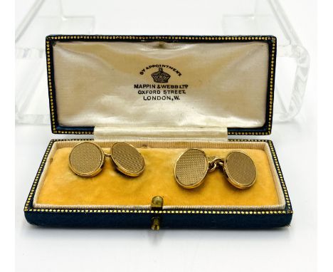A pair of 9ct gold cufflinks with engine turned faces, 12.5g. Estimate: £260-300