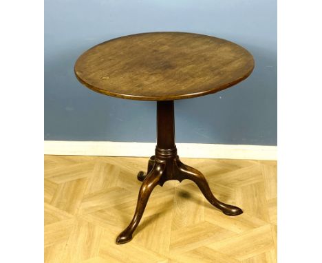 An 18th century Georgian mahogany tilt top tripod table with a tapered central cylindrical column and supported on shaped leg