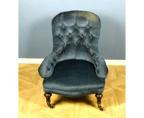 19th century Gillows button back nursing chair with turned and fluted walnut front legs with brass cup castors, back legs sta