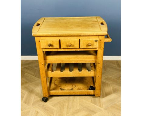A small contemporary hardwood kitchen unit, incorporating a removable top cutting board with cutout handles, above three frie
