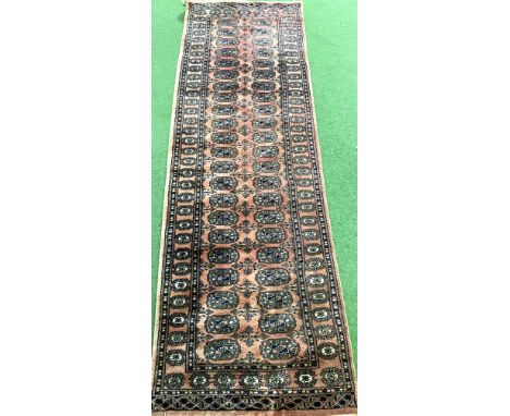 A red ground mina khani wool runner, 242cm x 80cm. Estimate: £40-60