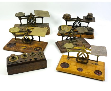 Five early to mid 20th century sets of postal scales and various brass weights, largest 22.5cms wide x 12.5cms deep x 12cms h