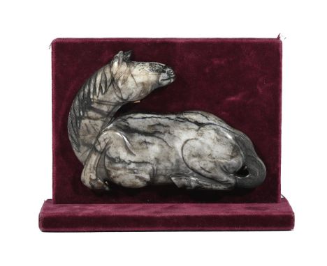 A Chinese black and white jade carving of a recumbent horse, Ming dynasty, the horse with finely detailed facial features, ma
