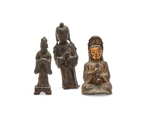 A Chinese bronze parcel-gilt figure of Guanyin and child, Ming dynasty, 16th or 17th century, the deity cast with a serene ex