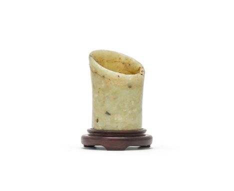 A Chinese celadon jade hoof-shaped ornament, Neolithic period, Longshan culture (circa 3000 - 1900 BC), with wood standProven