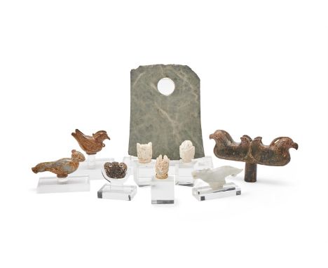 A group of various Chinese hardstone carvings, comprising: three carved mythical heads, approximately 5.2cm high; a brown sto