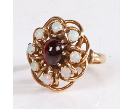 9 Carat Gold, opal and garnet ring, in the form of a flower head, with a central garnet surrounded by eight opals, ring size 