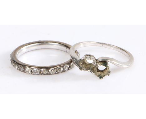 White coloured metal eternity ring set with a band of diamonds (three missing), ring size L, white metal ring formerly set wi