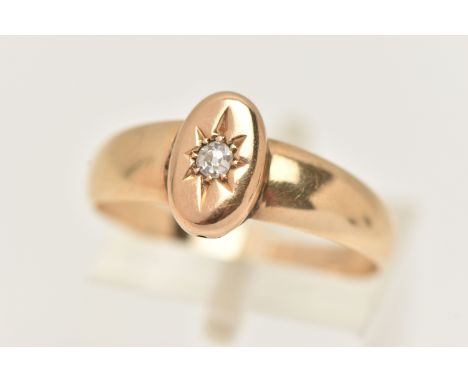 A YELLOW METAL RING, an oval yellow metal mount set with a single old cut diamond, fitted with a tapered shank, unmarked, rin