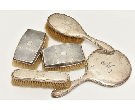 FIVE SILVER VANITY ITEMS, to include a matching hair brush, hand held mirror, and a clothes brush, polished designs with wavy