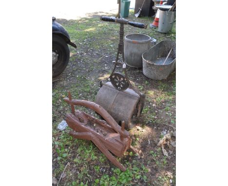 A VINTAGE CAST IRON GARDEN ROLLER with wheel motif to handle diameter 16in with self righting handle along with a modern wood