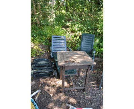 A SELECTION OF GARDEN FURNITURE including two Green plastic sun loungers and one folding chair and a hardwood table (4)